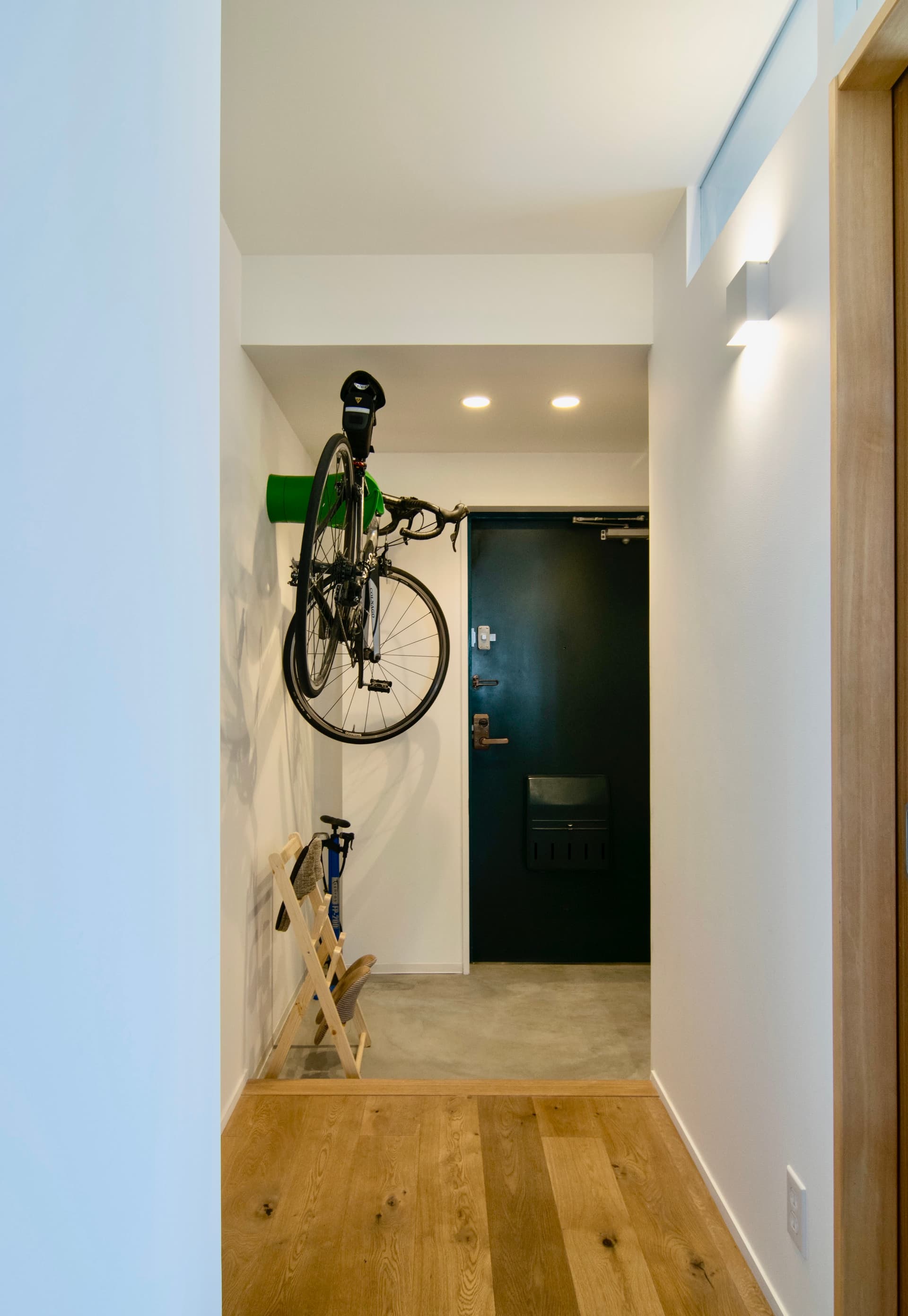 玄関です。ロードバイクを吊るせるようになっています。玄関と玄関収納の床はモルタルです。