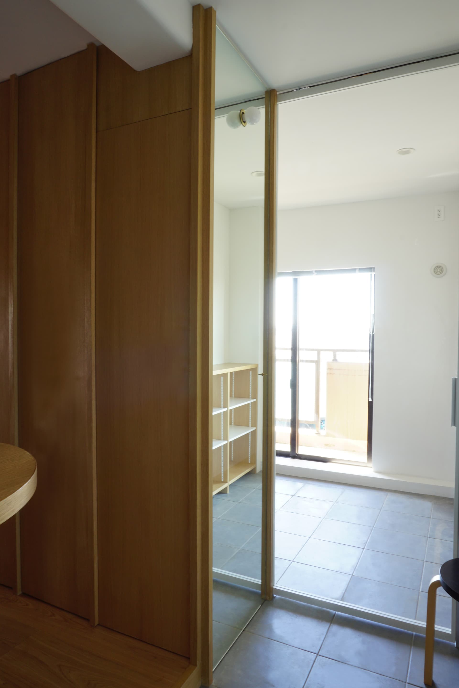 収納の側面に姿見をはめ込むように設置しました。靴を履いてコートを着て外の環境に近い太陽光のもとでコーディネートを楽しめるようにしました。