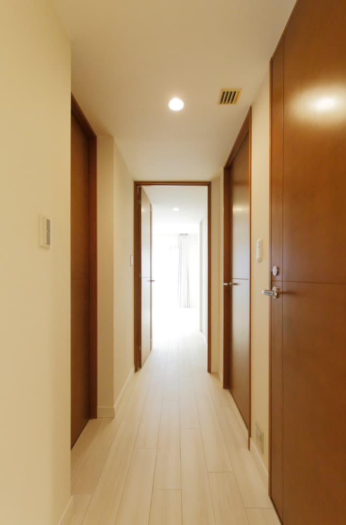 廊下。玄関から居室へと続く廊下は、明るさが感じられる気持ちの良いスペースです。扉を開けると奥まで視線が抜け、実際の広さ以上の開放感があります。